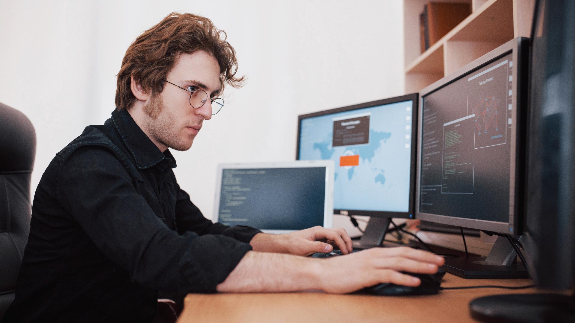 male programmer working on desktop computer